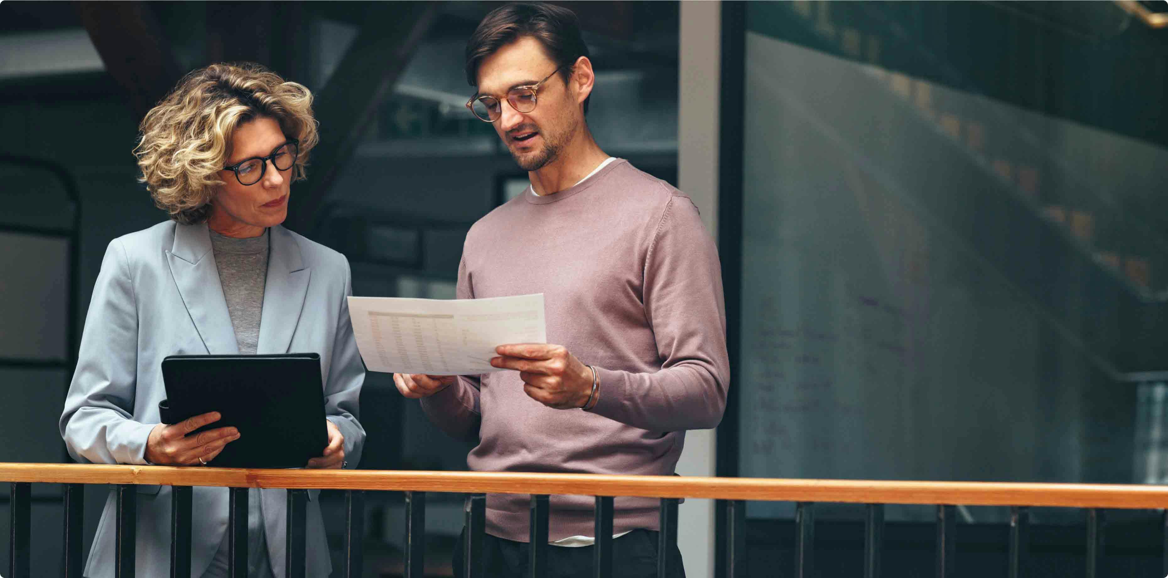 Two persons discussing business out on the balcony