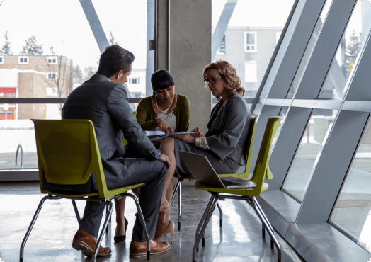 Three people are having a business conversation