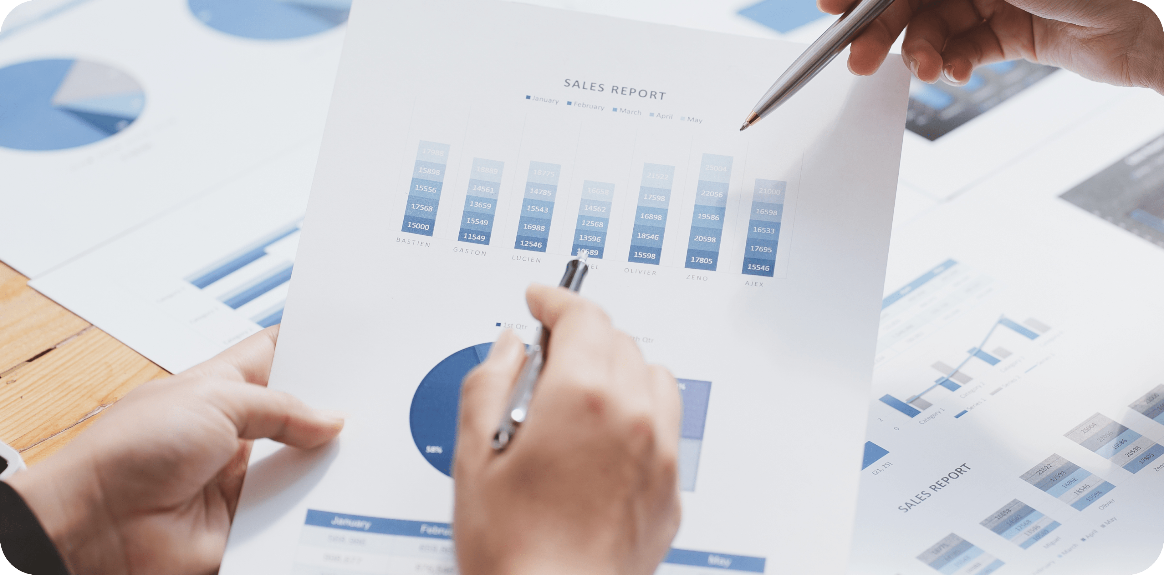 Hands and a piece of paper with charts on it